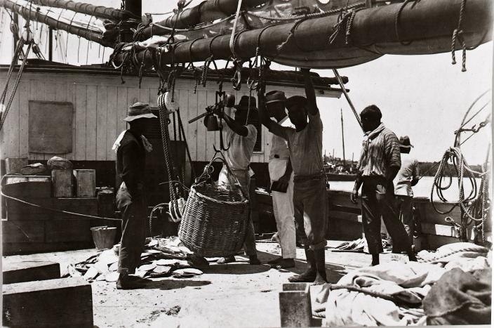 A group of men aboard a lugger. 